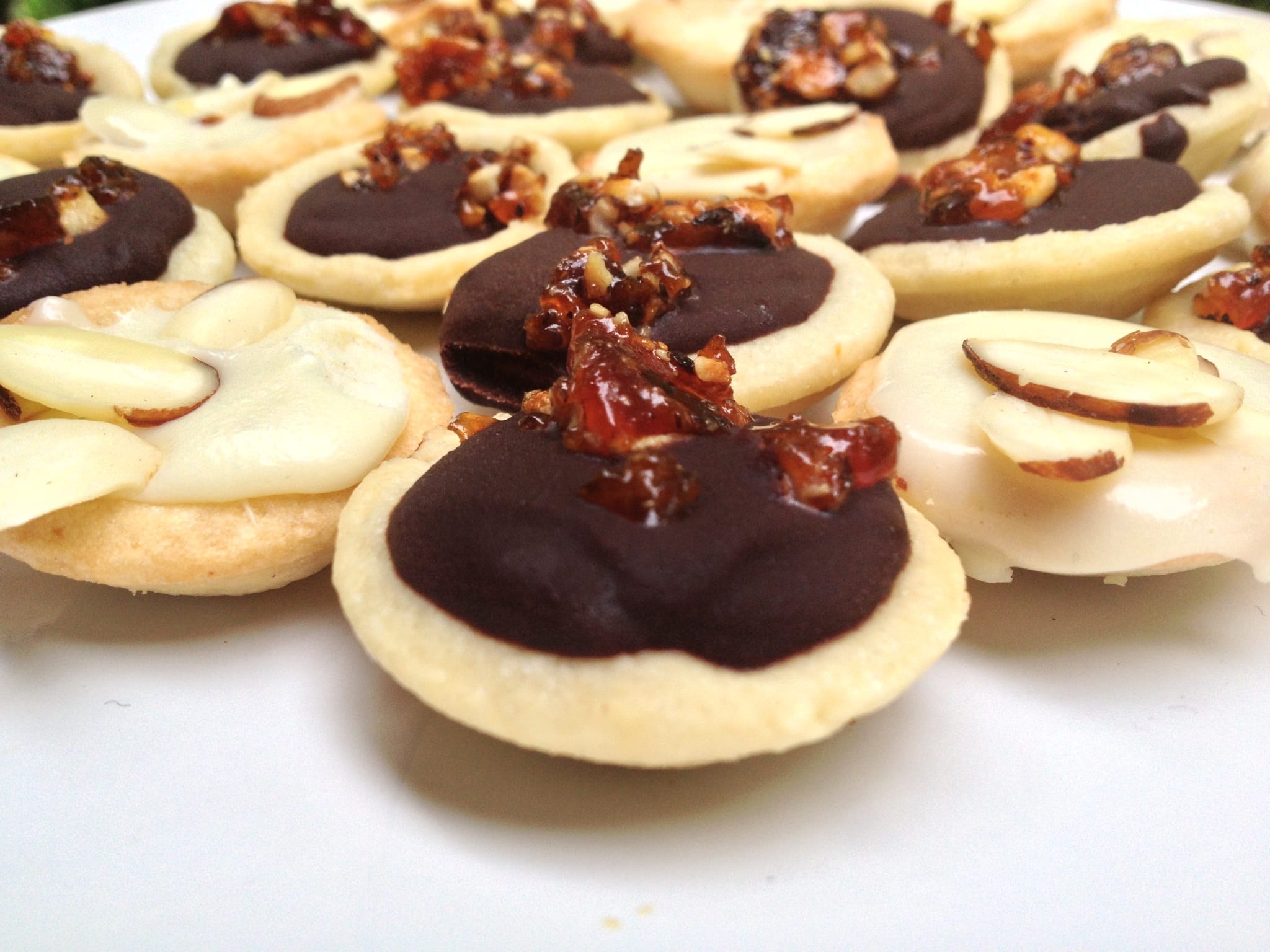 Mini Dark Chocolate and White Chocolate Ganache Tarts with Hazelnut Brittle and Almonds
